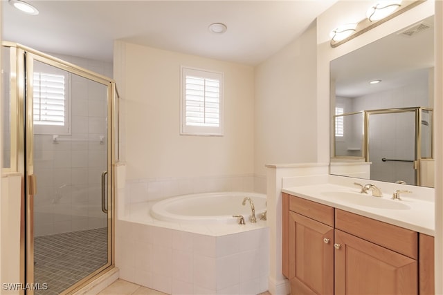 bathroom featuring plus walk in shower, tile patterned flooring, and vanity