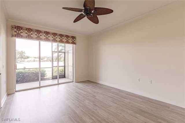 unfurnished room with baseboards, ornamental molding, a ceiling fan, and light wood finished floors