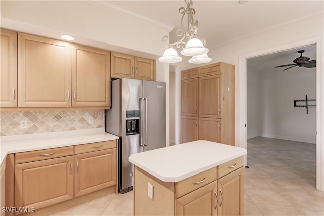 kitchen with tasteful backsplash, ceiling fan with notable chandelier, light tile patterned floors, a center island, and light brown cabinetry