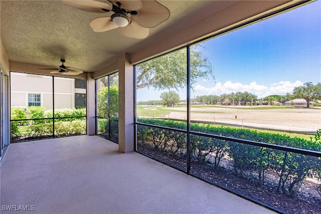 unfurnished sunroom featuring ceiling fan