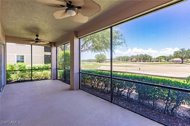 unfurnished sunroom featuring ceiling fan