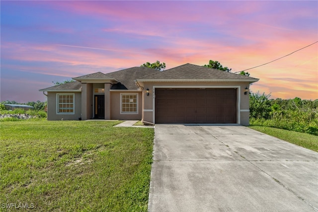 view of front of house with a yard and a garage