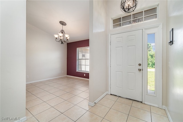 foyer featuring light tile patterned floors and a chandelier