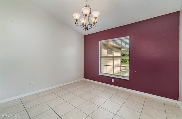 unfurnished room featuring a notable chandelier, light tile patterned flooring, and vaulted ceiling