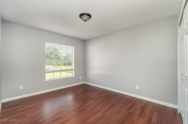 spare room with dark hardwood / wood-style flooring