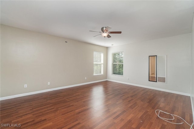 empty room with ceiling fan and dark wood-type flooring