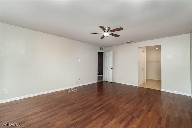 unfurnished room with ceiling fan and dark hardwood / wood-style flooring