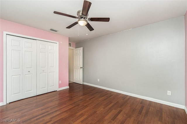 unfurnished bedroom with ceiling fan, a closet, and dark hardwood / wood-style floors