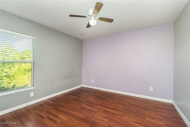 empty room with dark hardwood / wood-style floors and ceiling fan