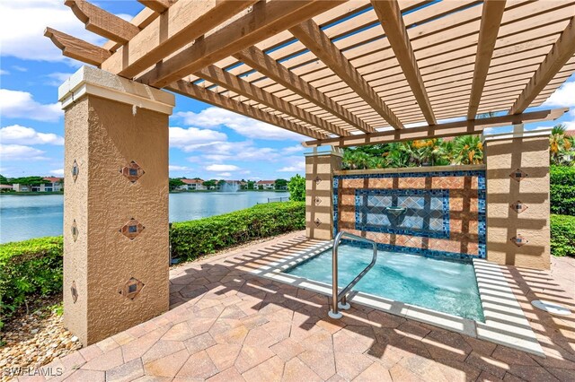 view of swimming pool featuring a patio, a water view, and a pergola