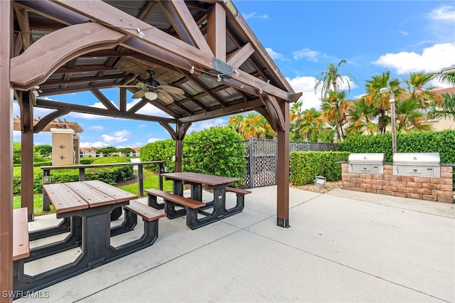 view of patio / terrace with an outdoor kitchen, ceiling fan, a gazebo, and grilling area