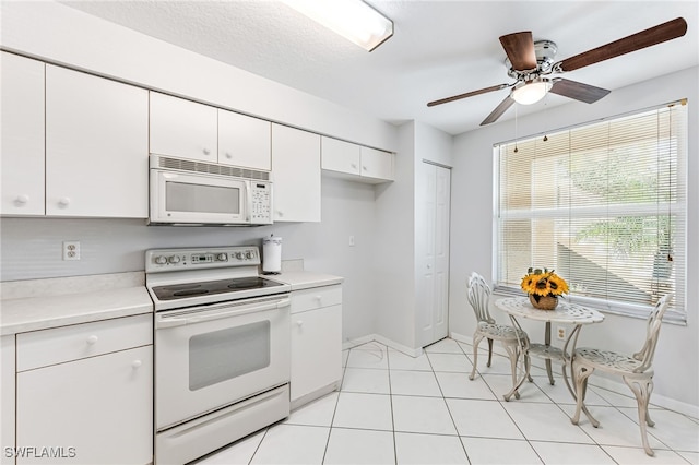 kitchen with ceiling fan, white cabinets, light tile patterned flooring, white appliances, and a textured ceiling