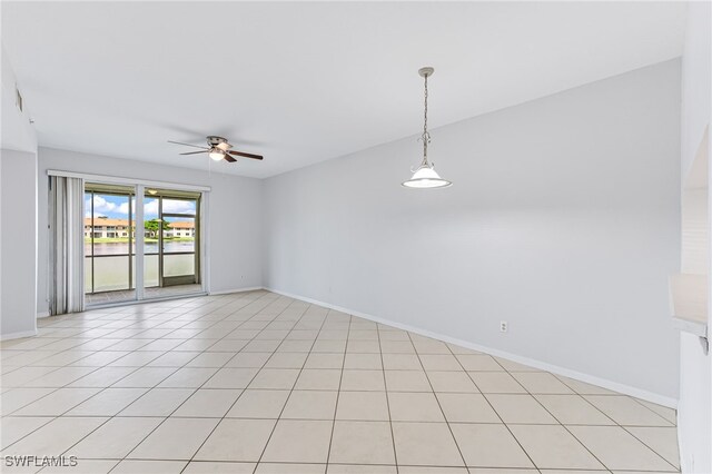 tiled spare room with ceiling fan