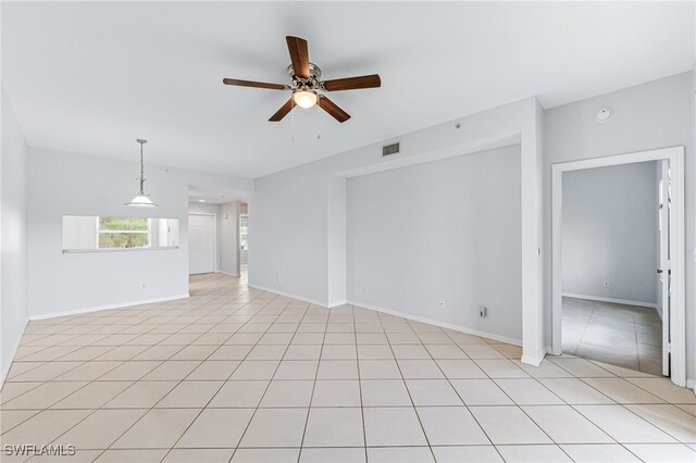 tiled spare room featuring ceiling fan