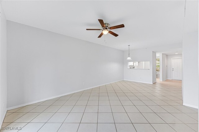 spare room with light tile patterned floors and ceiling fan