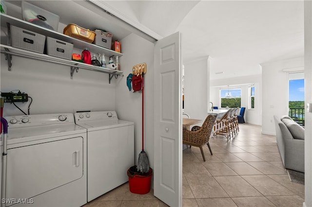 laundry room with independent washer and dryer and light tile patterned flooring