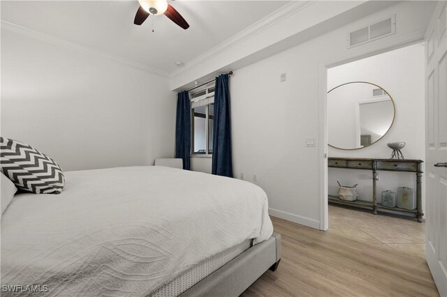 bedroom featuring light hardwood / wood-style flooring, ceiling fan, and ornamental molding