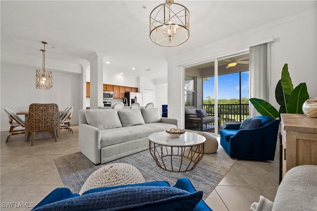 living area with light tile patterned floors, ornamental molding, a notable chandelier, and recessed lighting