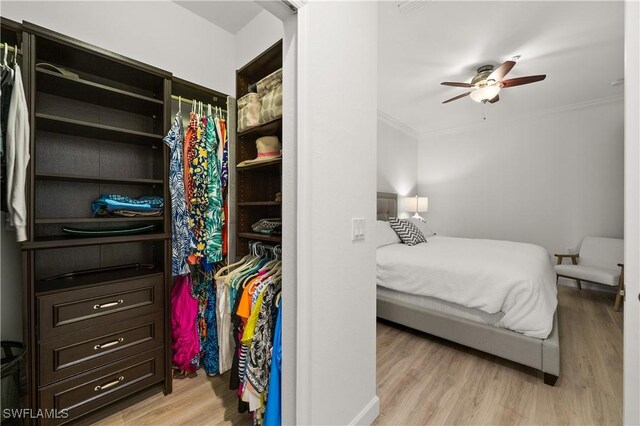 bedroom featuring light hardwood / wood-style floors, ornamental molding, and ceiling fan