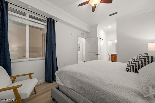 bedroom with hardwood / wood-style floors, crown molding, connected bathroom, and ceiling fan