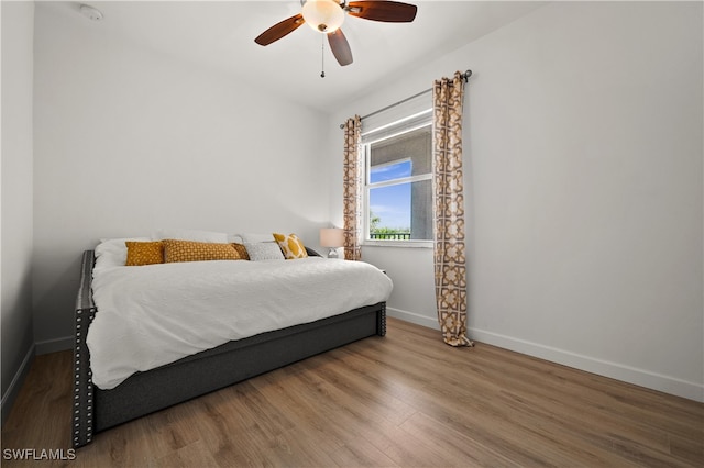 bedroom with ceiling fan and wood-type flooring