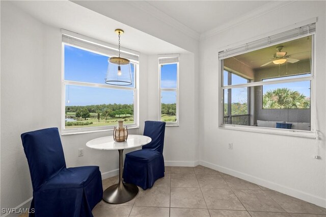 interior space with light tile patterned floors, crown molding, and ceiling fan