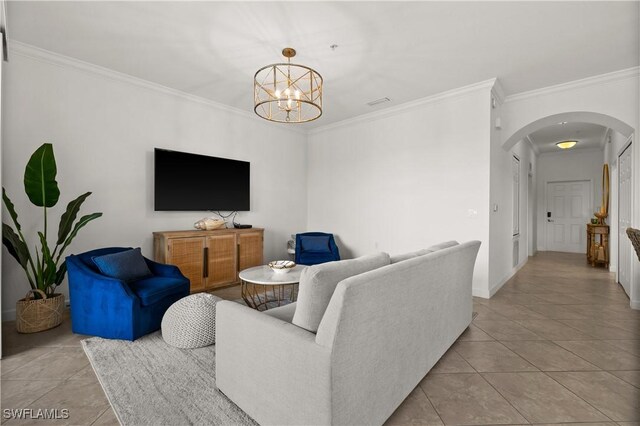 living room featuring ornamental molding, light tile patterned floors, and an inviting chandelier