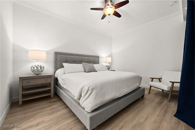 bedroom with ceiling fan, hardwood / wood-style floors, and ornamental molding