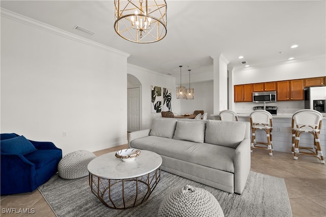 tiled living room with crown molding and a notable chandelier