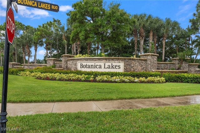 community / neighborhood sign featuring a lawn