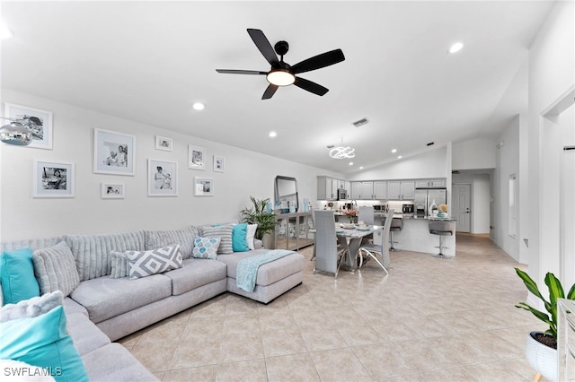 tiled living room with ceiling fan and vaulted ceiling