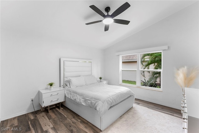 bedroom with ceiling fan, vaulted ceiling, and hardwood / wood-style floors