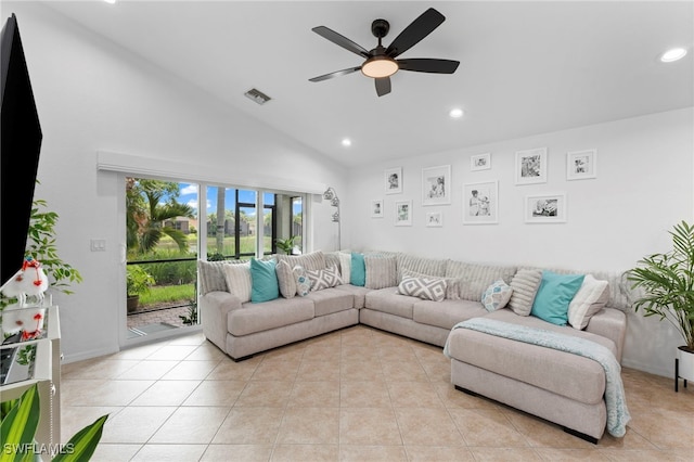 tiled living room with ceiling fan and vaulted ceiling