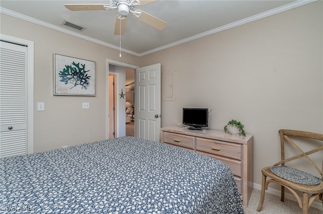 bedroom featuring ceiling fan, a closet, and crown molding