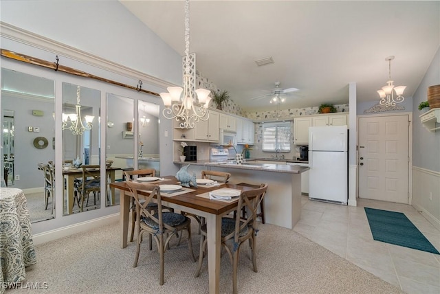 dining area featuring light tile patterned floors, visible vents, vaulted ceiling, and ceiling fan with notable chandelier