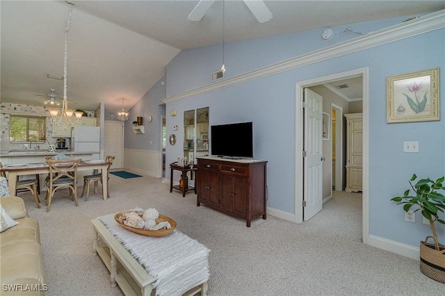 living area featuring light colored carpet, lofted ceiling, visible vents, and ceiling fan with notable chandelier