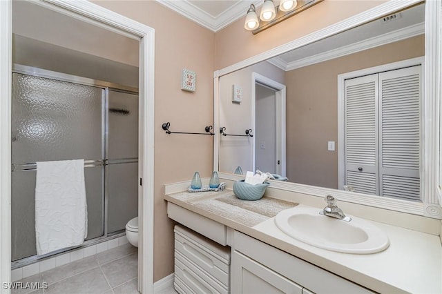 bathroom featuring toilet, a shower stall, ornamental molding, and tile patterned floors