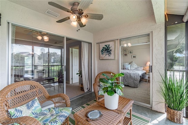 sunroom / solarium with ceiling fan and visible vents