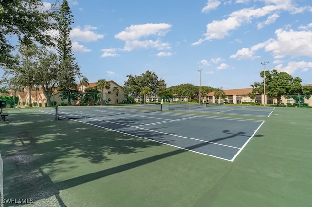 view of tennis court with basketball hoop