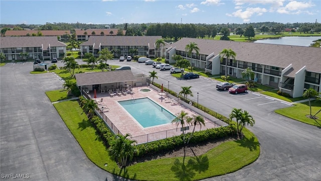 drone / aerial view with a water view and a residential view