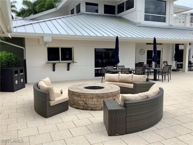 view of patio featuring outdoor dining area and an outdoor living space with a fire pit