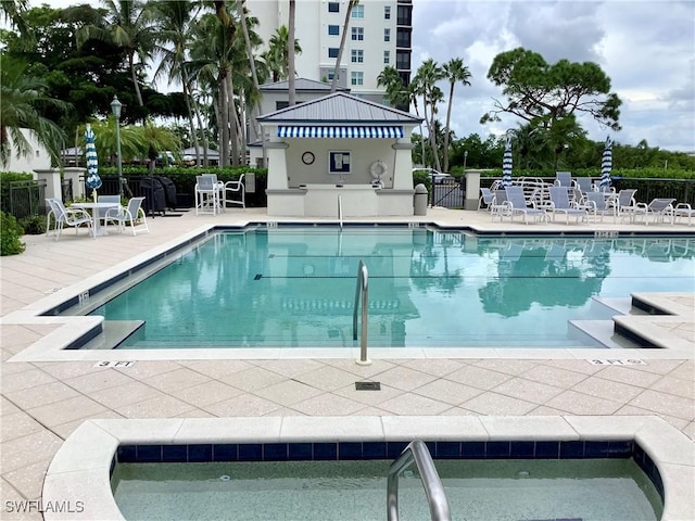 pool featuring fence and a patio