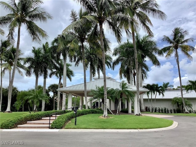 exterior space featuring metal roof and a front lawn