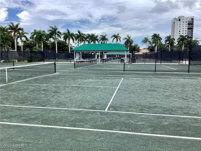 view of tennis court featuring fence