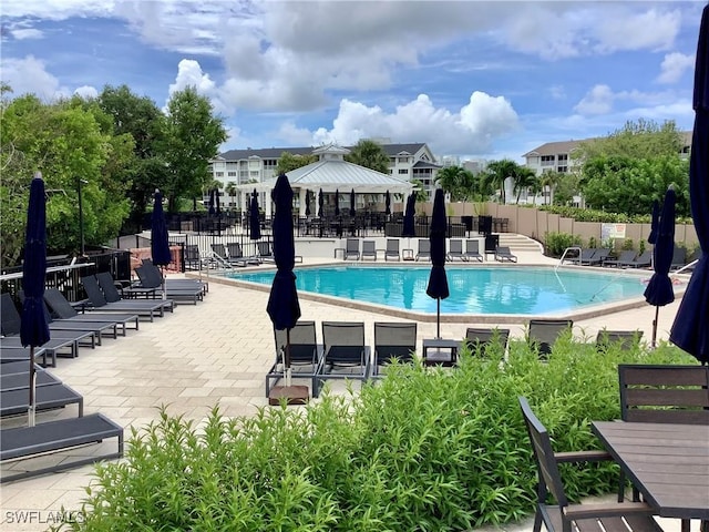 pool featuring a patio, a gazebo, and fence