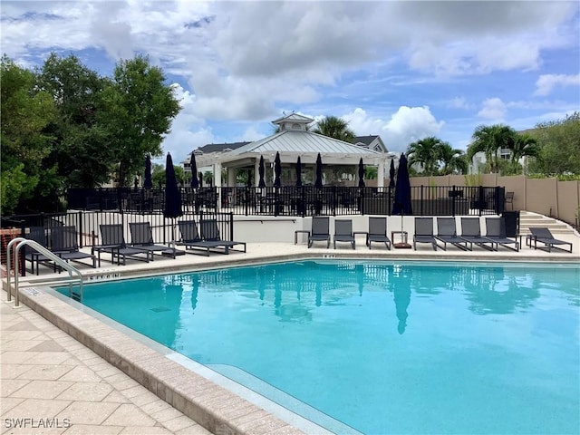 pool with a gazebo and fence