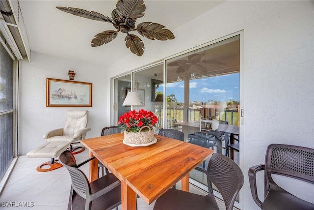 sunroom featuring ceiling fan and plenty of natural light