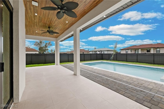 view of swimming pool with ceiling fan and a patio area