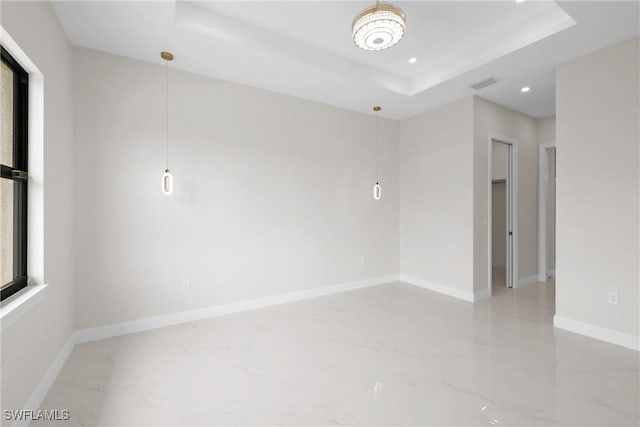 spare room featuring a tray ceiling