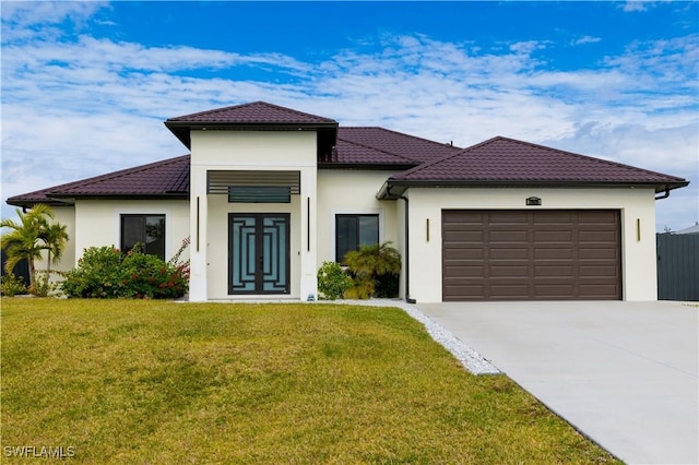 mediterranean / spanish house featuring a garage and a front yard